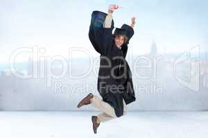 Composite image of happy male student in graduate robe jumping