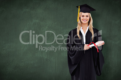 Composite image of smiling blonde student in graduate robe holdi