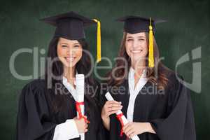 Composite image of two friends stand together after graduating
