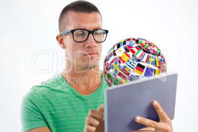 Composite image of man wearing glasses while using tablet comput