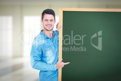 Composite image of happy man pointing to card