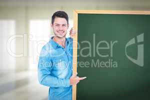 Composite image of happy man pointing to card