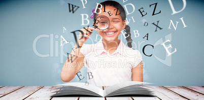 Composite image of little girl with magnifying glass