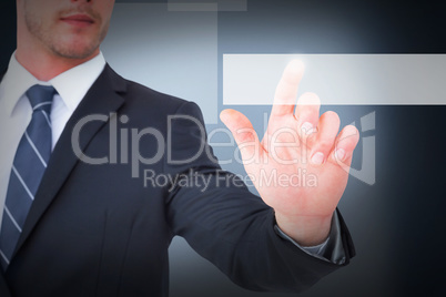 Composite image of focused businessman pointing with his finger