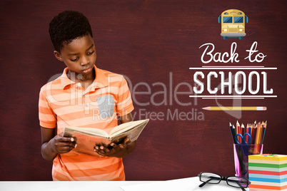 Composite image of cute boy reading book in library