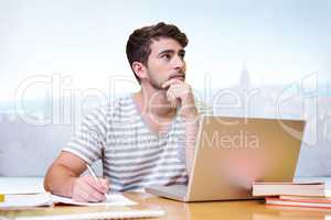 Composite image of student studying in the library with laptop
