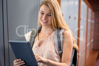 Composite image of happy student using tablet
