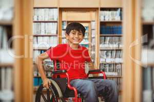 Composite image of portrait of boy sitting in wheelchair