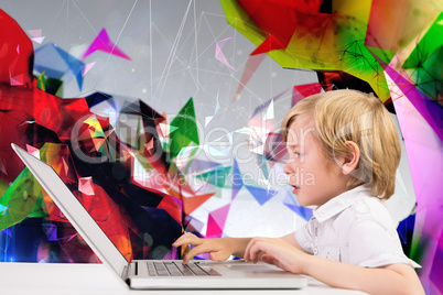 Composite image of cute boy using laptop