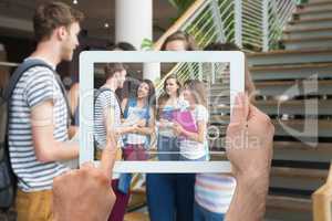 Composite image of hand holding tablet pc