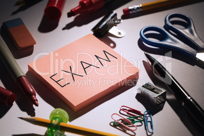 Exam against students table with school supplies