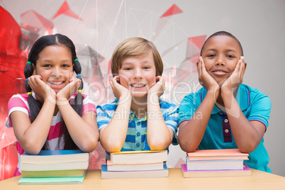 Composite image of cute pupils looking at camera in library