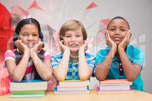 Composite image of cute pupils looking at camera in library