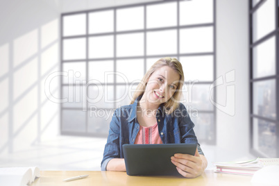 Composite image of student studying in the library with tablet