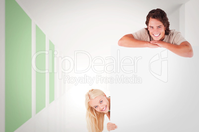 Composite image of smiling couple with whiteboard