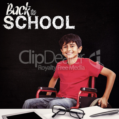 Composite image of portrait of boy sitting in wheelchair