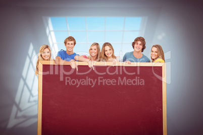 Composite image of smiling group of people with a blank space as
