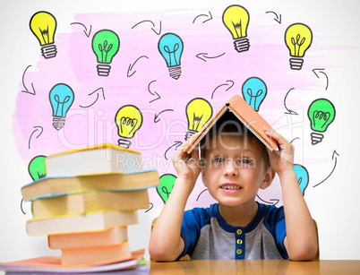 Composite image of cute boy with book on head