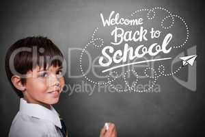 Composite image of cute pupil with chalkboard