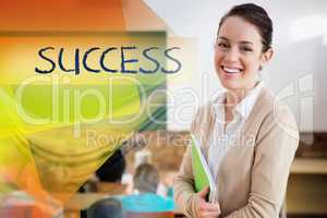 Success against pretty teacher smiling at camera at back of clas