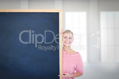 Composite image of happy woman pointing to card