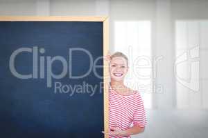 Composite image of happy woman pointing to card