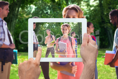 Composite image of hand holding tablet pc