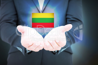 Composite image of businessman holding his hands out