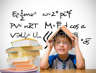 Composite image of cute boy with book on head