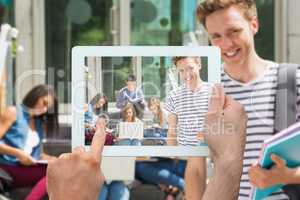 Composite image of hand holding tablet pc