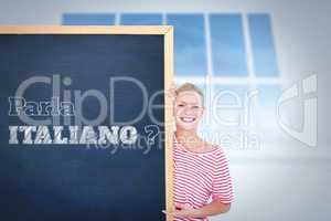 Composite image of happy woman pointing to card