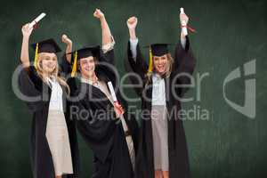 Composite image of three students in graduate robe raising their
