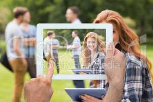 Composite image of hand holding tablet pc