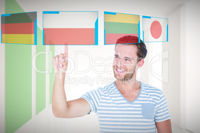 Composite image of handsome man pointing at something