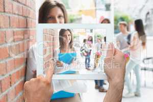 Composite image of hand holding tablet pc