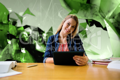 Composite image of student studying in the library with tablet