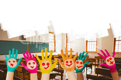 Composite image of hands with colourful smiley faces Composite image of hands with colourful smiley faces
