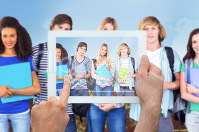 Composite image of hand holding tablet pc