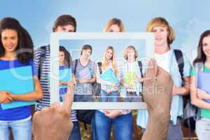 Composite image of hand holding tablet pc