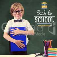 Composite image of cute pupil holding book