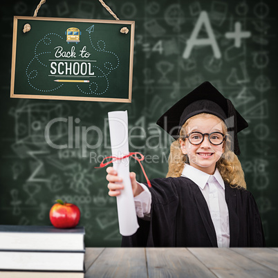 Composite image of schoolgirl with graduation robe and holding h