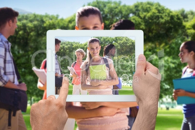 Composite image of hand holding tablet pc