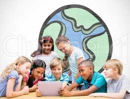 Composite image of cute pupils using tablet computer in library