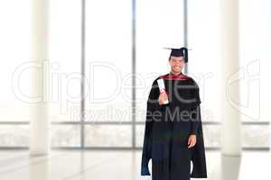 Composite image of charming graduate boy with his diploma