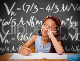 Composite image of cute pupil at desk