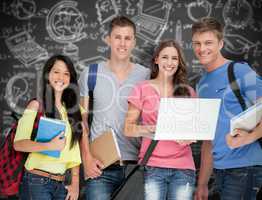 Composite image of a smiling group of students holding a laptop