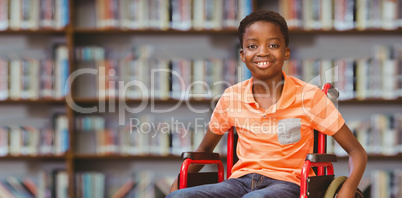 Composite image of portrait of boy sitting in wheelchair at libr
