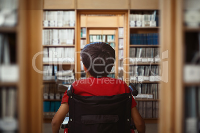 Composite image of rear view of boy sitting in wheelchair