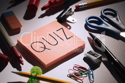 Quiz against students table with school supplies