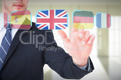 Composite image of focused businessman pointing with his finger